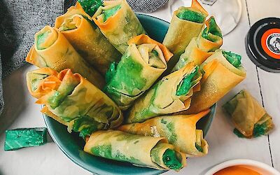 Making your own mini spring rolls with pesto cheese
