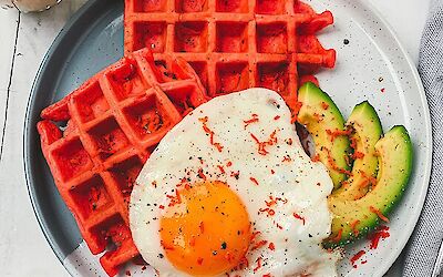 Making savoury breakfast waffles with red pesto cheese